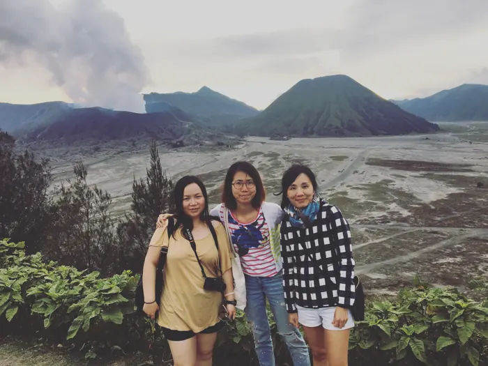 Three friends with Mount Bromo behind them